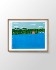 Fellow Traveler Indonesia surf painting by Alimo in natural wood frame, swimmer facing a jungle shoreline