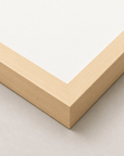 Alimo art print in a natural wood frame, corner detail